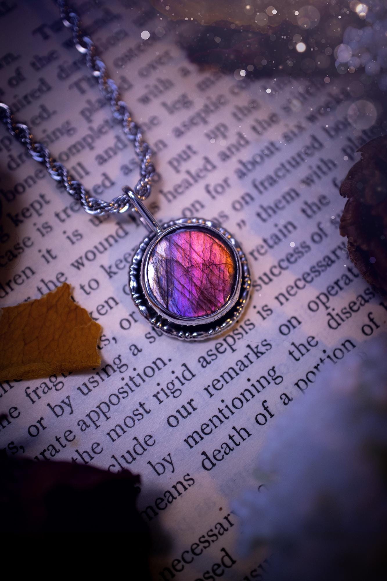Dainty but beautiful, handcrafted, natural pink, purple, and silver labradorite spectrolite pendant necklace. This beautiful pendant has been handmade using recycled fine and sterling silver. Featuring a round labradorite that is full of natural pinks, purples and silver hues. Around the crystal is a smooth inner bezel with gallery wire around as the outer bezel. This is the ideal piece of jewellery for a loved one or to treat yourself. Suitable for crystal and jewellery lovers. Gothic vibes.
