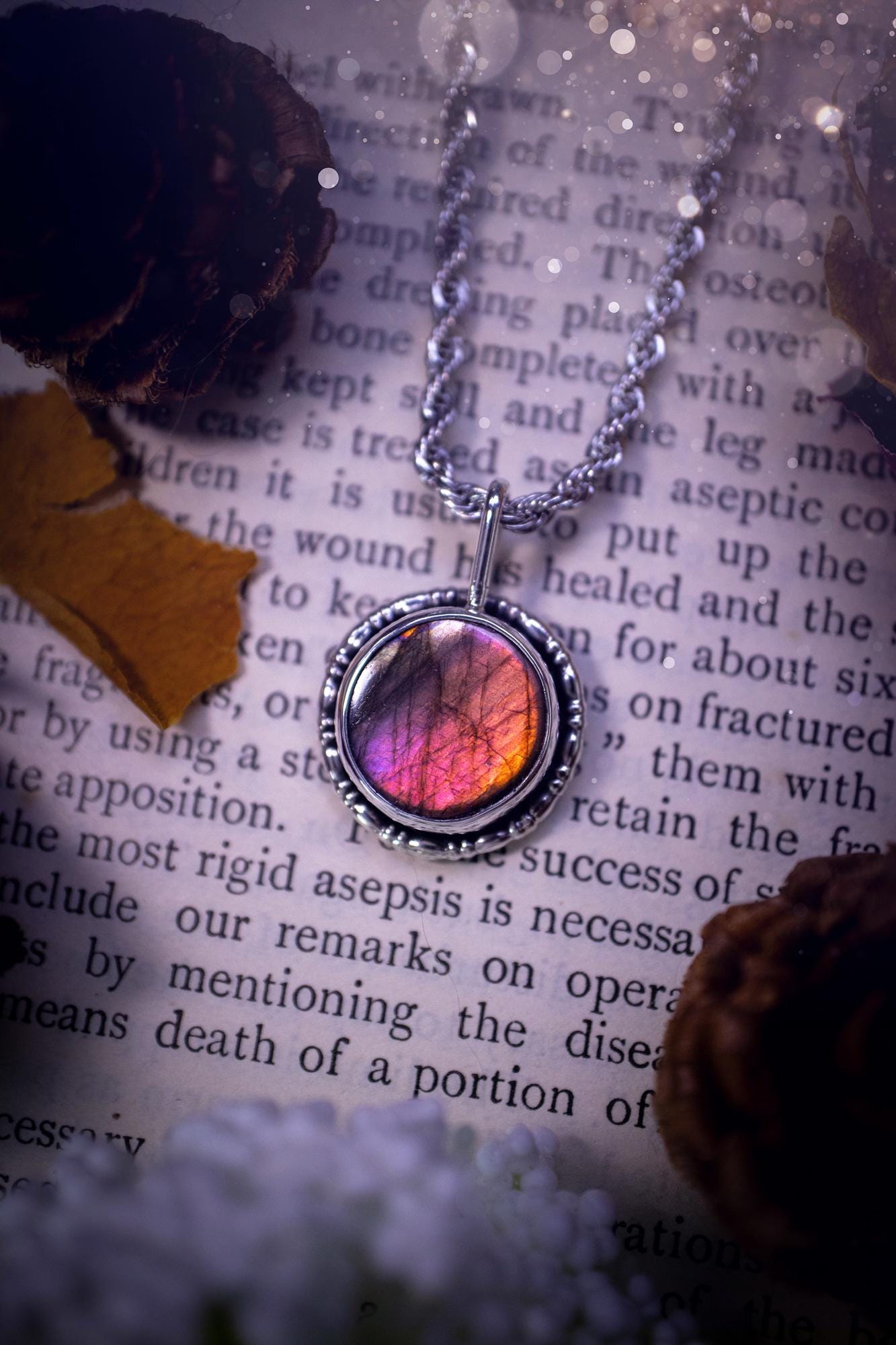 Dainty but beautiful, handcrafted, natural pink, purple, and silver labradorite spectrolite pendant necklace. This beautiful pendant has been handmade using recycled fine and sterling silver. Featuring a round labradorite that is full of natural pinks, purples and silver hues. Around the crystal is a smooth inner bezel with gallery wire around as the outer bezel. This is the ideal piece of jewellery for a loved one or to treat yourself. Suitable for crystal and jewellery lovers. Gothic vibes.