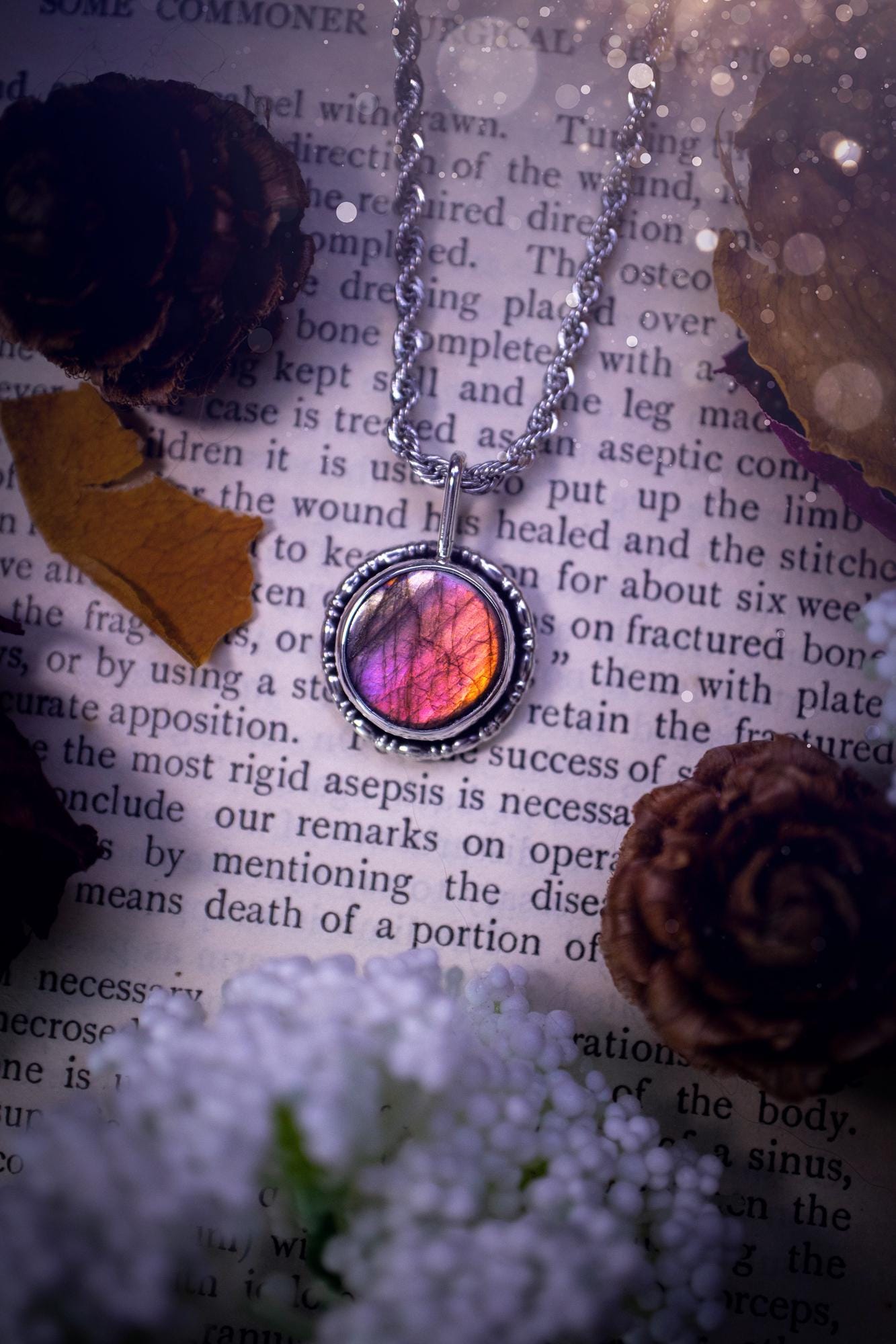 Dainty but beautiful, handcrafted, natural pink, purple, and silver labradorite spectrolite pendant necklace. This beautiful pendant has been handmade using recycled fine and sterling silver. Featuring a round labradorite that is full of natural pinks, purples and silver hues. Around the crystal is a smooth inner bezel with gallery wire around as the outer bezel. This is the ideal piece of jewellery for a loved one or to treat yourself. Suitable for crystal and jewellery lovers. Gothic vibes.