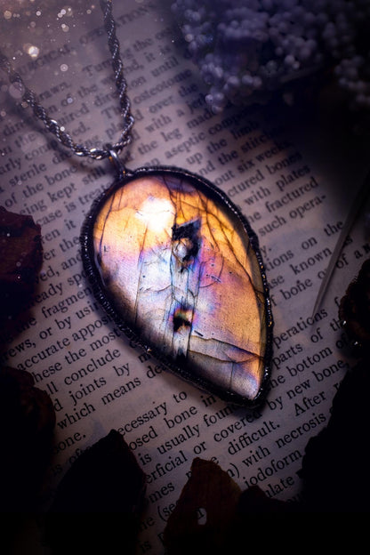 The ultimate labradorite soft soldered pendant necklace. This pendant necklace features the most beautiful, natural and very unique Labradorite spectrolite crystal that has so many hues of silver, purple, pink and orange. Handmade using the tiffany technique, also known as soft soldering. This piece is made from solder which contains silver and is safe to wear. The ideal gift for any jewellery lover and crystal collector! Witchy, gothic and hippy jewellery that has been made for the soul.
