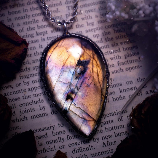 The ultimate labradorite soft soldered pendant necklace. This pendant necklace features the most beautiful, natural and very unique Labradorite spectrolite crystal that has so many hues of silver, purple, pink and orange. Handmade using the tiffany technique, also known as soft soldering. This piece is made from solder which contains silver and is safe to wear. The ideal gift for any jewellery lover and crystal collector! Witchy, gothic and hippy jewellery that has been made for the soul.