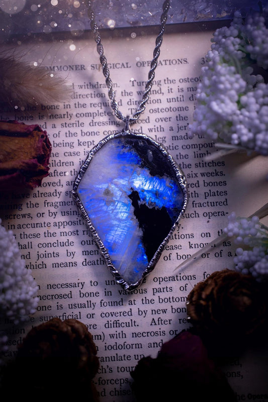 Handmade and beautiful, rainbow moonstone slab, soft soldered pendant necklace. This pendant necklace features the most gorgeous and flashy rainbow moonstone slab crystal, full of glittery shimmer and a deep lovely blue hue. Handcrafted using the soft solder method, also known as the tiffany technique, an ancient technique used to created stained glass windows. The solder used is lead free and totally safe to wear, it contains elements of silver and polishes up to a high lustre. Gothic jewellery