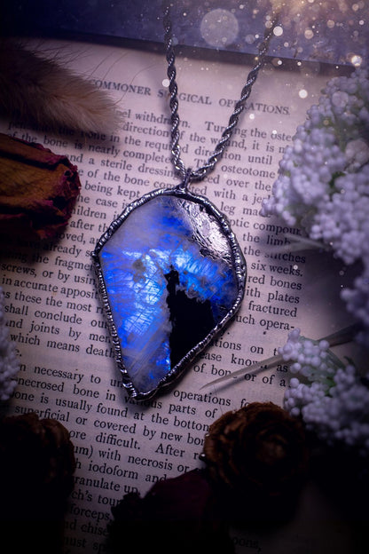 Handmade and beautiful, rainbow moonstone slab, soft soldered pendant necklace. This pendant necklace features the most gorgeous and flashy rainbow moonstone slab crystal, full of glittery shimmer and a deep lovely blue hue. Handcrafted using the soft solder method, also known as the tiffany technique, an ancient technique used to created stained glass windows. The solder used is lead free and totally safe to wear, it contains elements of silver and polishes up to a high lustre. Gothic jewellery