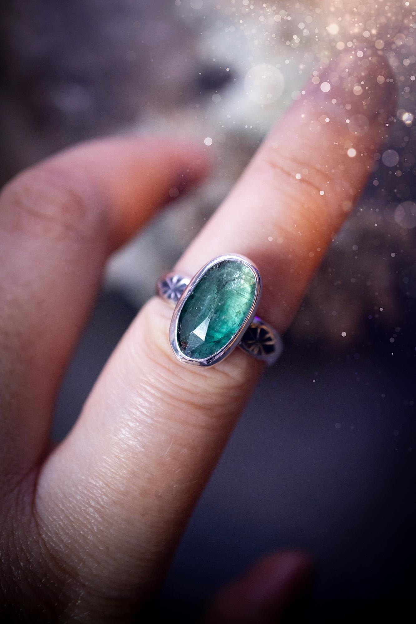 Beautiful and handcrafted, natural teal green kyanite crystal, staking ring. This stunning ring has been hand made using fine and sterling silver. It features a beautiful and natural teal green kyanite crystal that has rainbows and flash, such a gorgeous colour. The ring shank on this ring has been stamped with a gothic pattern to give it a one of a kind vibe. Ideal gift for that special person in your life, or for any crystal and jewellery lover. Hippy, witchy and gothic jewellery for the soul.