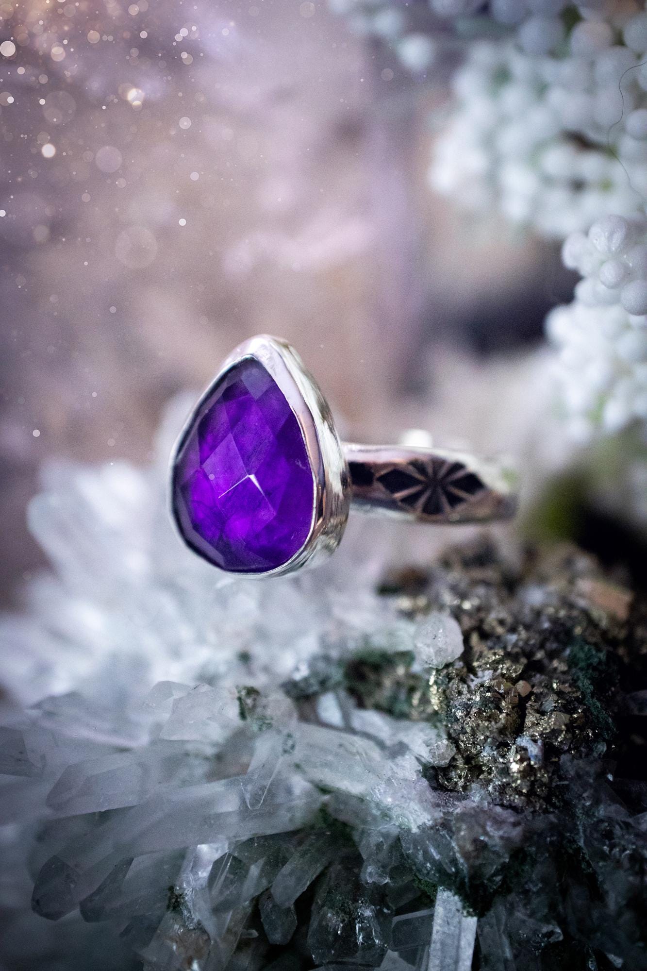 Beautiful and handcrafted, natural purple amethyst crystal, staking ring. This stunning ring has been hand made using fine and sterling silver. It features a beautiful and natural purple amethyst crystal that is rose cut with such a gorgeous colour. The ring shank on this ring has been stamped with a gothic pattern to give it a one of a kind vibe. Ideal gift for that special person in your life, or for any crystal and jewellery lover. Hippy, witchy and gothic jewellery for the soul.