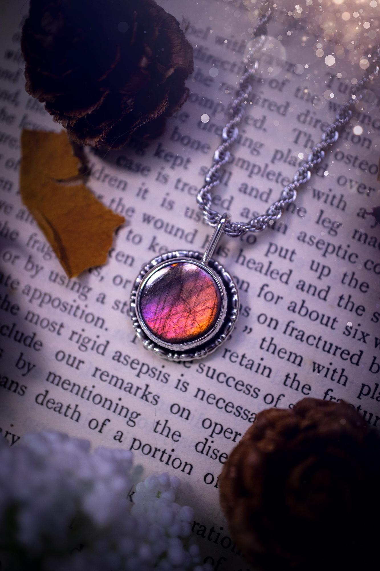 Dainty but beautiful, handcrafted, natural pink, purple, and silver labradorite spectrolite pendant necklace. This beautiful pendant has been handmade using recycled fine and sterling silver. Featuring a round labradorite that is full of natural pinks, purples and silver hues. Around the crystal is a smooth inner bezel with gallery wire around as the outer bezel. This is the ideal piece of jewellery for a loved one or to treat yourself. Suitable for crystal and jewellery lovers. Gothic vibes.