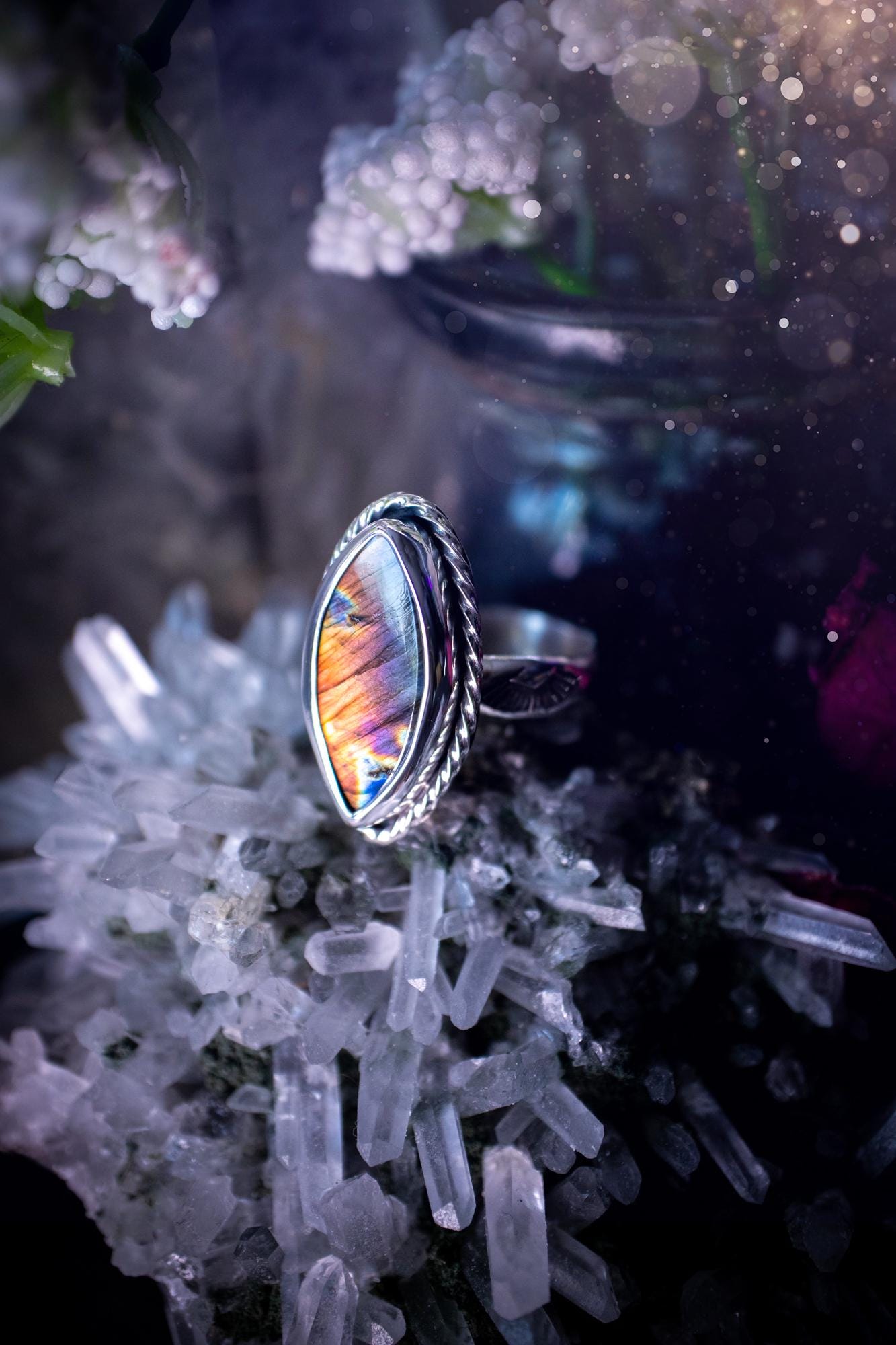 Handcrafted sterling silver statement ring featuring a stunning spectrolite labradorite crystal with vibrant flashes of purple, pink, and orange. This magical gemstone shimmers with an ethereal glow, making it a captivating piece for any jewellery collection. Ideal for crystal lovers, spiritual souls, and those drawn to unique, one-of-a-kind designs. A bold, mystical accessory perfect for expressing your inner light and energy. Gothic and handmade jewellery gifts, ideal for crystal lovers.