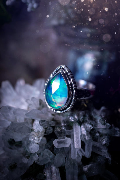 Beautiful and handmade, aurora synthetic opal, sterling silver bespoke ring. This ring has been handmade using a mix of recycled fine and sterling silver. Featuring a beautiful multi flash aurora opal that is full of blue, greens and pink hues depending on the angle. The stone is also rose cut and has a lovely sparkle. This piece is ideal for any jewellery or crystal lover and is full of witchy and hippy vibes! A beautiful mini statement ring for anyone&#39;s collection.