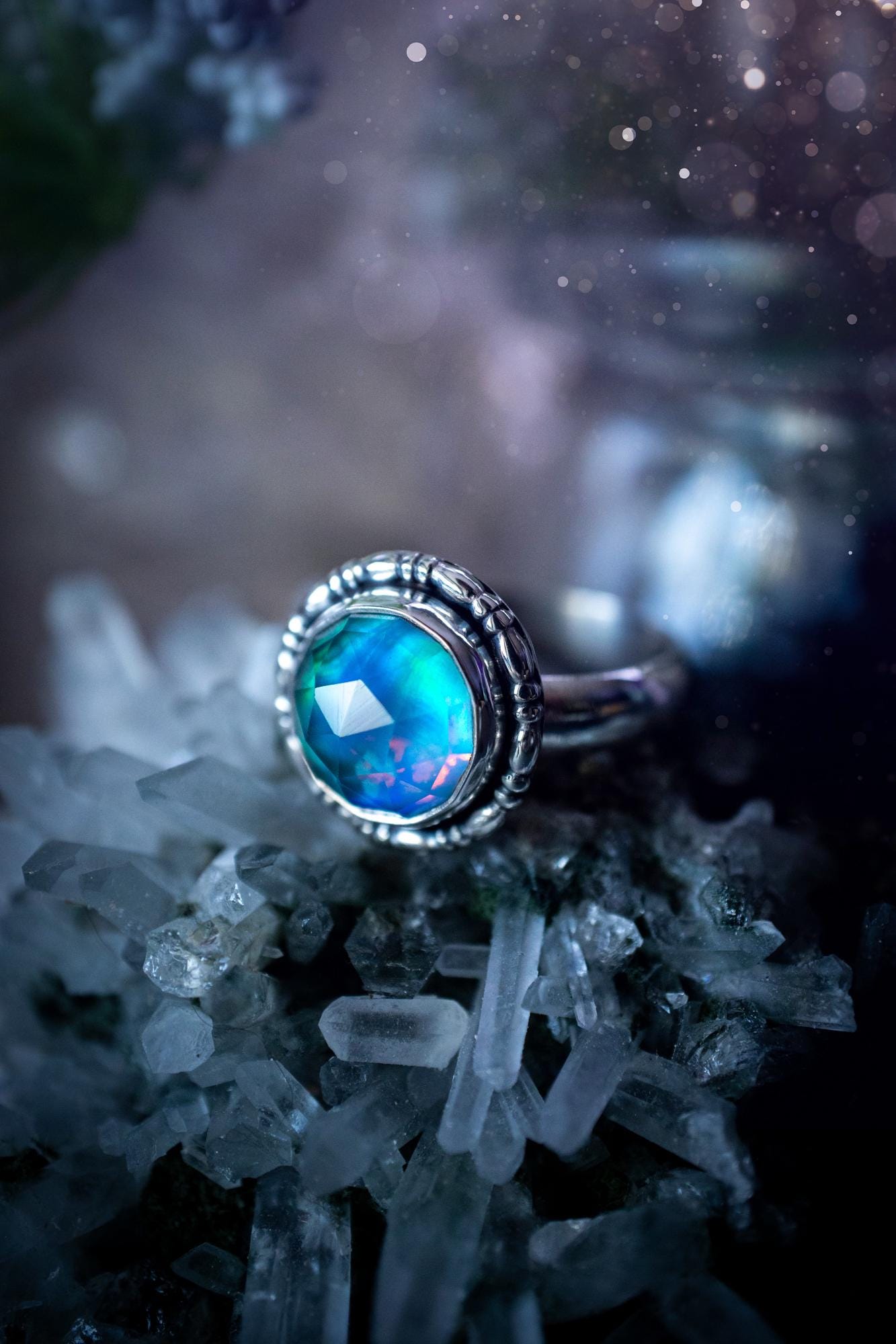 Beautiful and handmade, aurora synthetic opal, sterling silver bespoke ring. This ring has been handmade using a mix of recycled fine and sterling silver. Featuring a beautiful multi flash aurora opal that is full of blue, greens and pink hues depending on the angle. The stone is also rose cut and has a lovely sparkle. This piece is ideal for any jewellery or crystal lover and is full of witchy and hippy vibes! A beautiful mini statement ring for anyone&#39;s collection.