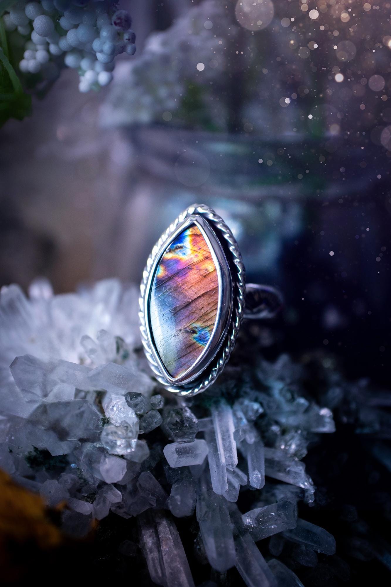 Handcrafted sterling silver statement ring featuring a stunning spectrolite labradorite crystal with vibrant flashes of purple, pink, and orange. This magical gemstone shimmers with an ethereal glow, making it a captivating piece for any jewellery collection. Ideal for crystal lovers, spiritual souls, and those drawn to unique, one-of-a-kind designs. A bold, mystical accessory perfect for expressing your inner light and energy. Gothic and handmade jewellery gifts, ideal for crystal lovers.