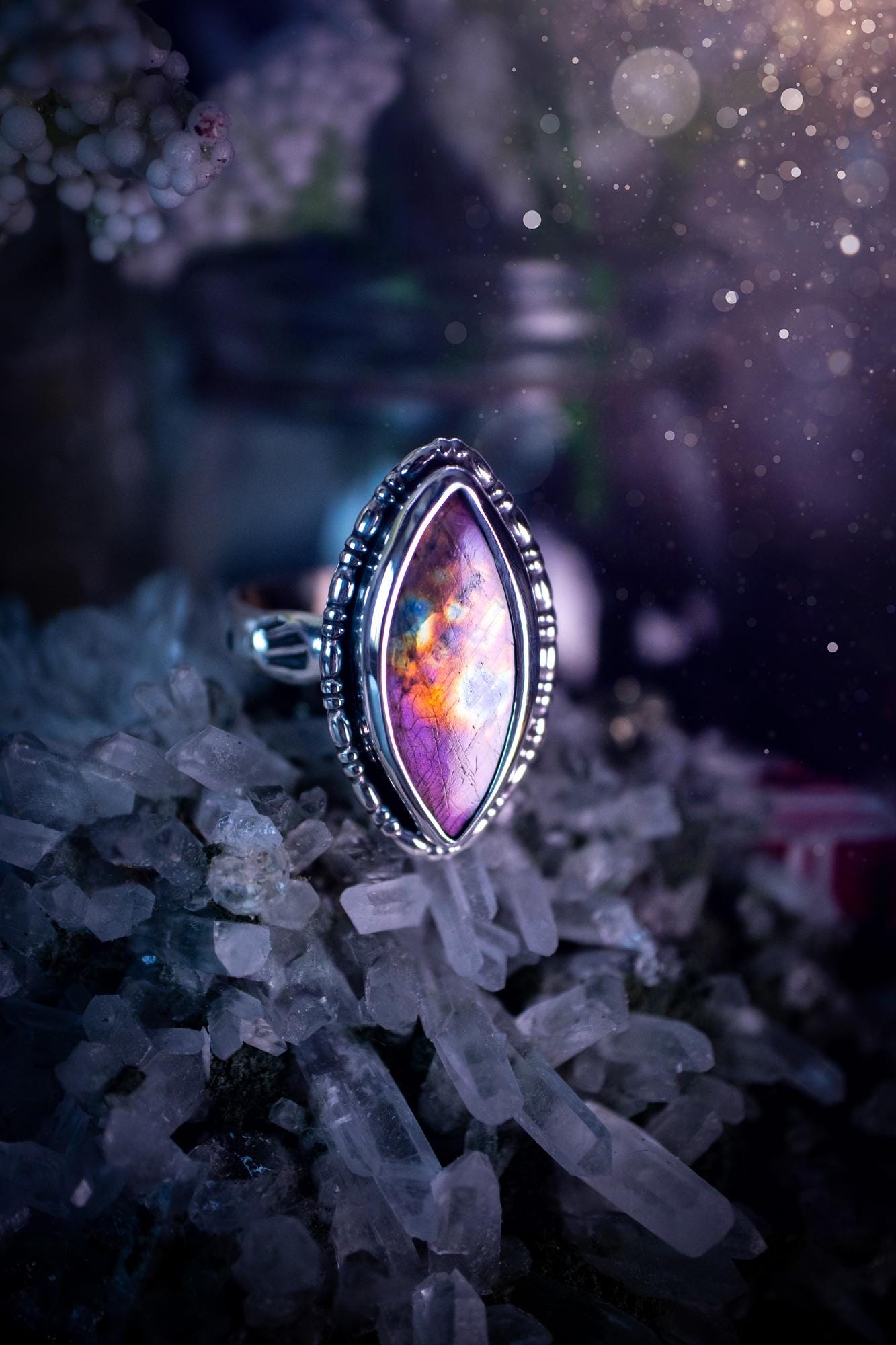 Handcrafted sterling silver statement ring featuring a stunning spectrolite labradorite crystal with vibrant flashes of purple, pink, and orange. This magical gemstone shimmers with an ethereal glow, making it a captivating piece for any jewellery collection. Ideal for crystal lovers, spiritual souls, and those drawn to unique, one-of-a-kind designs. A bold, mystical accessory perfect for expressing your inner light and energy. Gothic and handmade jewellery gifts, ideal for crystal lovers.