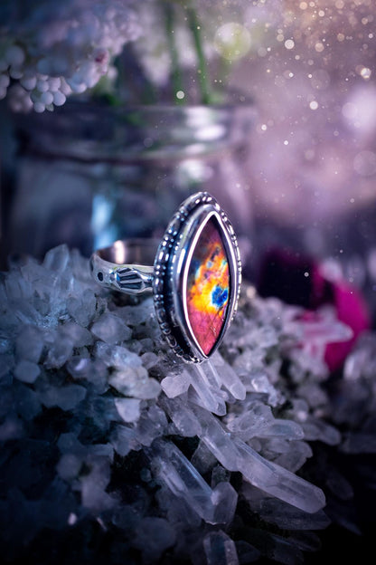 Handcrafted sterling silver statement ring featuring a stunning spectrolite labradorite crystal with vibrant flashes of purple, pink, and orange. This magical gemstone shimmers with an ethereal glow, making it a captivating piece for any jewellery collection. Ideal for crystal lovers, spiritual souls, and those drawn to unique, one-of-a-kind designs. A bold, mystical accessory perfect for expressing your inner light and energy. Gothic and handmade jewellery gifts, ideal for crystal lovers.