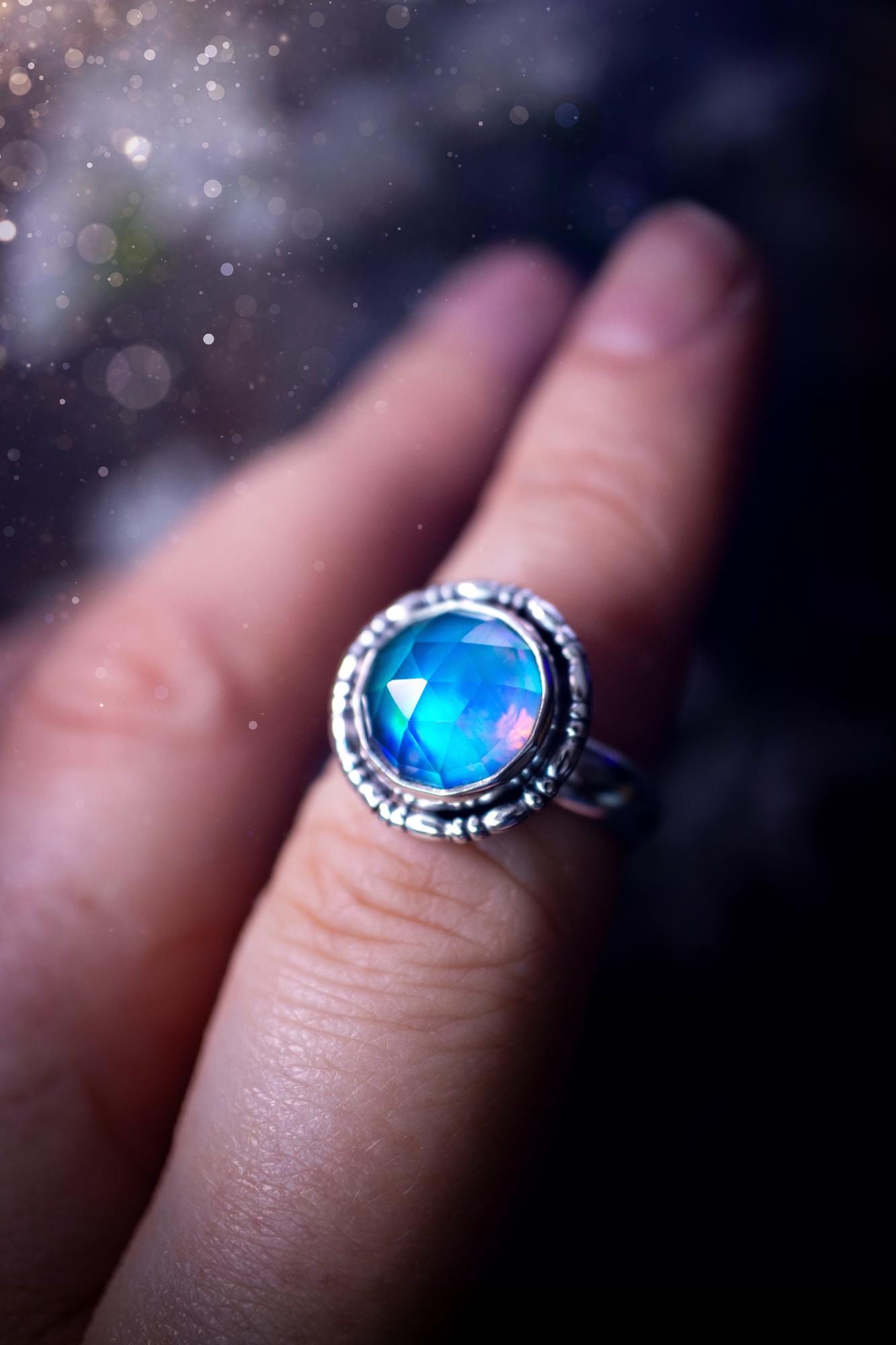 Beautiful and handmade, aurora synthetic opal, sterling silver bespoke ring. This ring has been handmade using a mix of recycled fine and sterling silver. Featuring a beautiful multi flash aurora opal that is full of blue, greens and pink hues depending on the angle. The stone is also rose cut and has a lovely sparkle. This piece is ideal for any jewellery or crystal lover and is full of witchy and hippy vibes! A beautiful mini statement ring for anyone&#39;s collection.