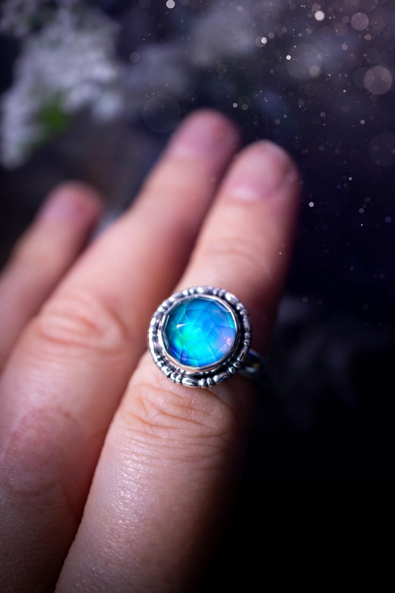 Beautiful and handmade, aurora synthetic opal, sterling silver bespoke ring. This ring has been handmade using a mix of recycled fine and sterling silver. Featuring a beautiful multi flash aurora opal that is full of blue, greens and pink hues depending on the angle. The stone is also rose cut and has a lovely sparkle. This piece is ideal for any jewellery or crystal lover and is full of witchy and hippy vibes! A beautiful mini statement ring for anyone&#39;s collection.
