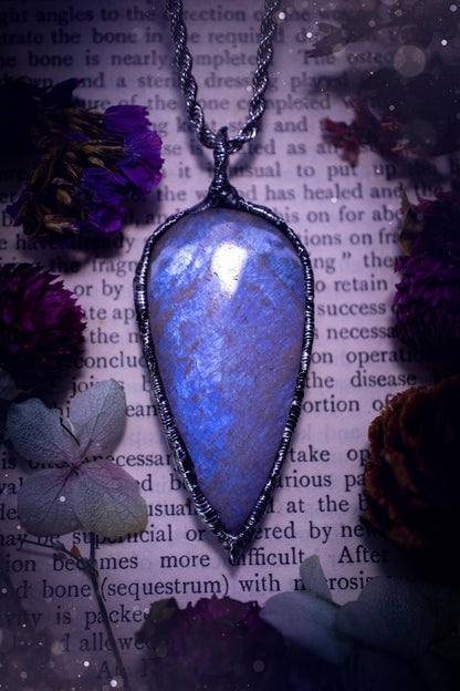 Handmade and beautiful, flashy belomorite, soft soldered pendant necklace. This pendant necklace features the most gorgeous and flashy belomorite moonstone crystal, full of glittery shimmer and a deep lovely blue hue. Handcrafted using the soft solder method, also known as the tiffany technique, an ancient technique used to created stained glass windows. The solder used is lead free and totally safe to wear, it contains elements of silver and polishes up to a high lustre. Gothic witchy jewellery