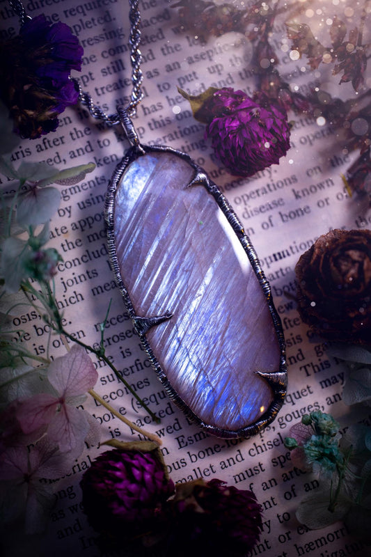 Handmade and beautiful, flashy belomorite, soft soldered pendant necklace. This pendant necklace features the most gorgeous and flashy belomorite moonstone crystal, full of glittery shimmer and a deep lovely blue hue. Handcrafted using the soft solder method, also known as the tiffany technique, an ancient technique used to created stained glass windows. The solder used is lead free and totally safe to wear, it contains elements of silver and polishes up to a high lustre. Gothic witchy jewellery