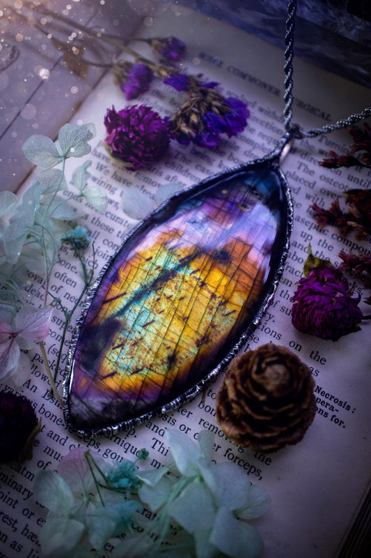 A very unique and one of a kind, soft soldered, labradorite, statement pendant necklace. The labradorite on this pendant is very unique as it is full of rainbow hues and is very large in size. Handmade using the soft solder method also known as the tiffany technique! This piece of jewellery is a must have for any crystal and jewellery lover, it is full of gothic and witchy vibes! Jewellery for the soul