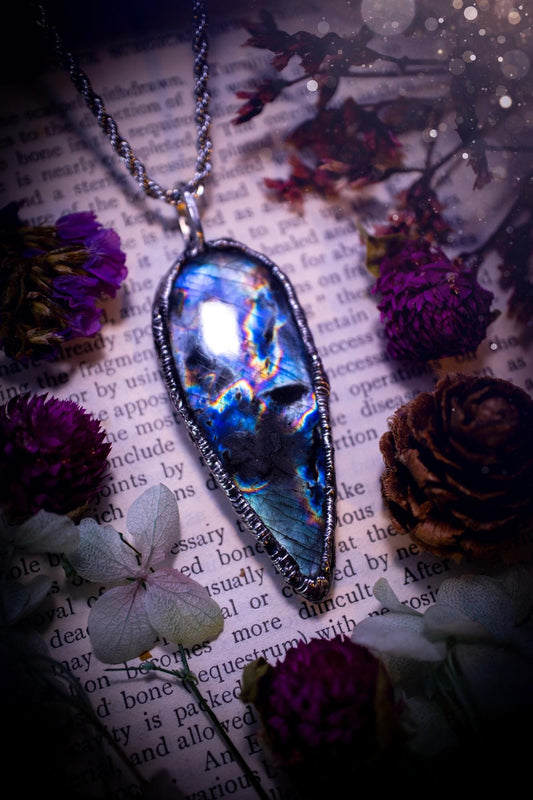 A very unique and one of a kind, soft soldered, labradorite, pendant necklace. The labradorite on this pendant is very unique as it is full of green, purples and blues, with little rainbow clusters. It also has two separate flashing areas on the crystal. Very vibrant and beautiful! Handmade using the soft solder method also known as the tiffany technique! This piece of jewellery is a must have for any crystal and jewellery lover, it is full of gothic and witchy vibes! Jewellery for the soul