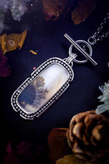 Stunning, bespoke and natural, scenic dendritic agate, sterling silver statement pendant necklace. This pendant necklace has been handmade using fine and sterling silver. It features a beautiful scenic dendritic agate that has a beautiful pattern that looks similar to little trees, a very unique and one of a kind jewellery piece. Around the crystal is a smooth bezel with smooth  and beaded wire. A lovely gift for any crystal and jewellery lover. This piece has a witchy and gothic vibes, hippy.