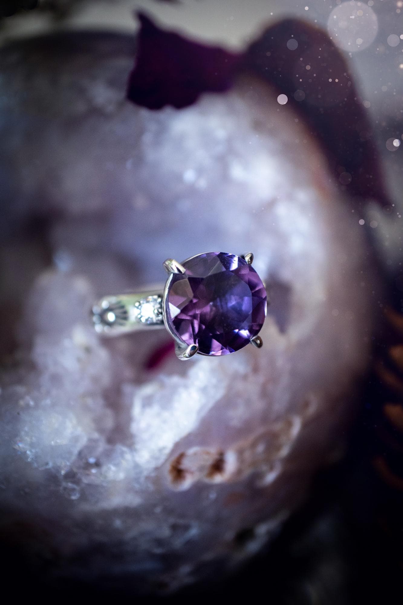 Beautifully handmade, and bespoke, natural amethyst crystal statement ring. This one of a kind ring has been handmade using a mix of fine and sterling silver. Featuring a beautiful, sparkly, round, natural amethyst crystal that has stunning hues of purple, along with cubic zirconia to the sides of the crystal. The ring band is stamped with unique detailing. The ideal treat and gift for anyone who is a lover of crystals and jewellery. This ring is full of gothic and witchy vibes! engagement ring