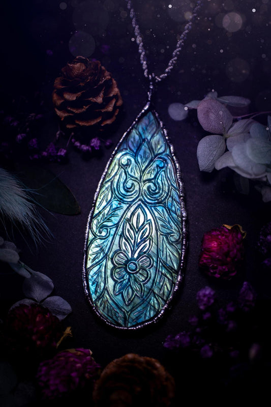 Beautifully handmade and bespoke, carved labradorite, soft soldered pendant necklace. This large labradorite pendant has been crafted using the soft solder method, also known as the tiffany technique. The crystal has a bezel of lead free soft solder which contains small parts of silver that allows for oxidisation and a high lustre polish. This labradorite is full of beautiful blues and greens and has been hand carved with a beautiful floral and leaf pattern. One off, gothic and witchy jewellery