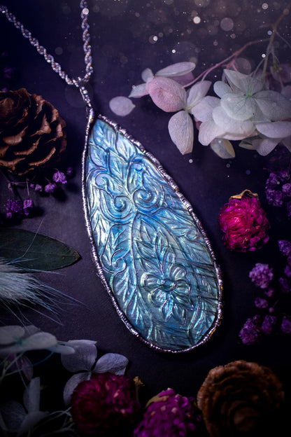 Beautifully handmade and bespoke, carved labradorite, soft soldered pendant necklace. This large labradorite pendant has been crafted using the soft solder method, also known as the tiffany technique. The crystal has a bezel of lead free soft solder which contains small parts of silver that allows for oxidisation and a high lustre polish. This labradorite is full of beautiful blues and greens and has been hand carved with a beautiful floral and leaf pattern. One off, gothic and witchy jewellery