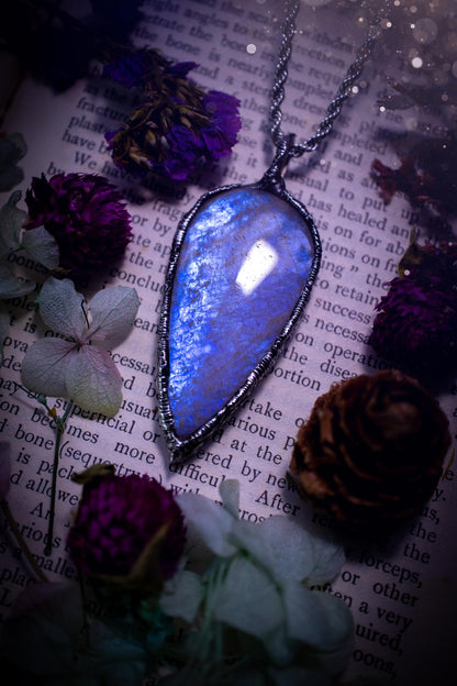 Handmade and beautiful, flashy belomorite, soft soldered pendant necklace. This pendant necklace features the most gorgeous and flashy belomorite moonstone crystal, full of glittery shimmer and a deep lovely blue hue. Handcrafted using the soft solder method, also known as the tiffany technique, an ancient technique used to created stained glass windows. The solder used is lead free and totally safe to wear, it contains elements of silver and polishes up to a high lustre. Gothic witchy jewellery