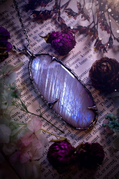 Handmade and beautiful, flashy belomorite, soft soldered pendant necklace. This pendant necklace features the most gorgeous and flashy belomorite moonstone crystal, full of glittery shimmer and a deep lovely blue hue. Handcrafted using the soft solder method, also known as the tiffany technique, an ancient technique used to created stained glass windows. The solder used is lead free and totally safe to wear, it contains elements of silver and polishes up to a high lustre. Gothic witchy jewellery