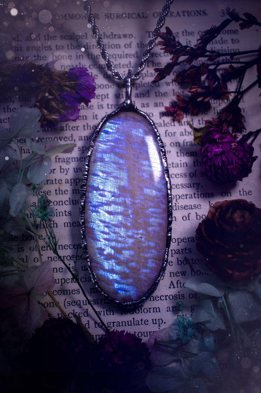 Handmade and beautiful, flashy belomorite, soft soldered pendant necklace. This pendant necklace features the most gorgeous and flashy belomorite moonstone crystal, full of glittery shimmer and a deep lovely blue hue. Handcrafted using the soft solder method, also known as the tiffany technique, an ancient technique used to created stained glass windows. The solder used is lead free and totally safe to wear, it contains elements of silver and polishes up to a high lustre. Gothic witchy jewellery