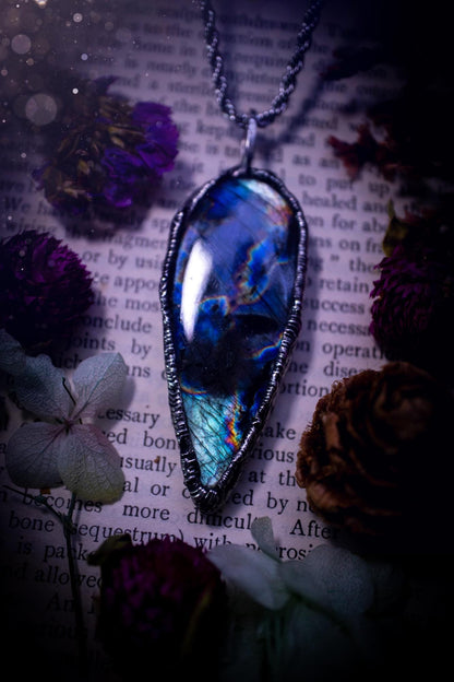 A very unique and one of a kind, soft soldered, labradorite, pendant necklace. The labradorite on this pendant is very unique as it is full of green, purples and blues, with little rainbow clusters. It also has two separate flashing areas on the crystal. Very vibrant and beautiful! Handmade using the soft solder method also known as the tiffany technique! This piece of jewellery is a must have for any crystal and jewellery lover, it is full of gothic and witchy vibes! Jewellery for the soul