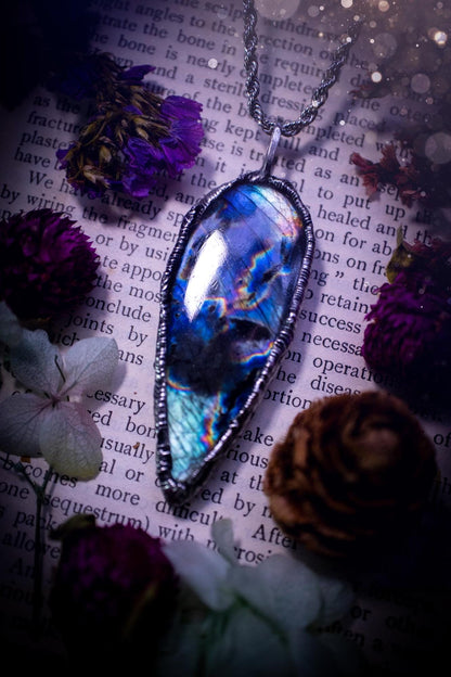 A very unique and one of a kind, soft soldered, labradorite, pendant necklace. The labradorite on this pendant is very unique as it is full of green, purples and blues, with little rainbow clusters. It also has two separate flashing areas on the crystal. Very vibrant and beautiful! Handmade using the soft solder method also known as the tiffany technique! This piece of jewellery is a must have for any crystal and jewellery lover, it is full of gothic and witchy vibes! Jewellery for the soul