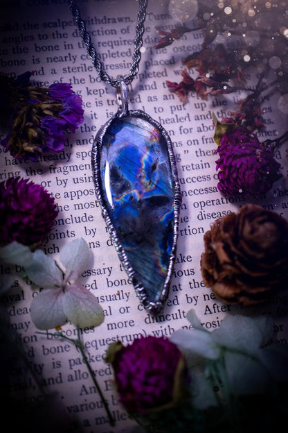 A very unique and one of a kind, soft soldered, labradorite, pendant necklace. The labradorite on this pendant is very unique as it is full of green, purples and blues, with little rainbow clusters. It also has two separate flashing areas on the crystal. Very vibrant and beautiful! Handmade using the soft solder method also known as the tiffany technique! This piece of jewellery is a must have for any crystal and jewellery lover, it is full of gothic and witchy vibes! Jewellery for the soul