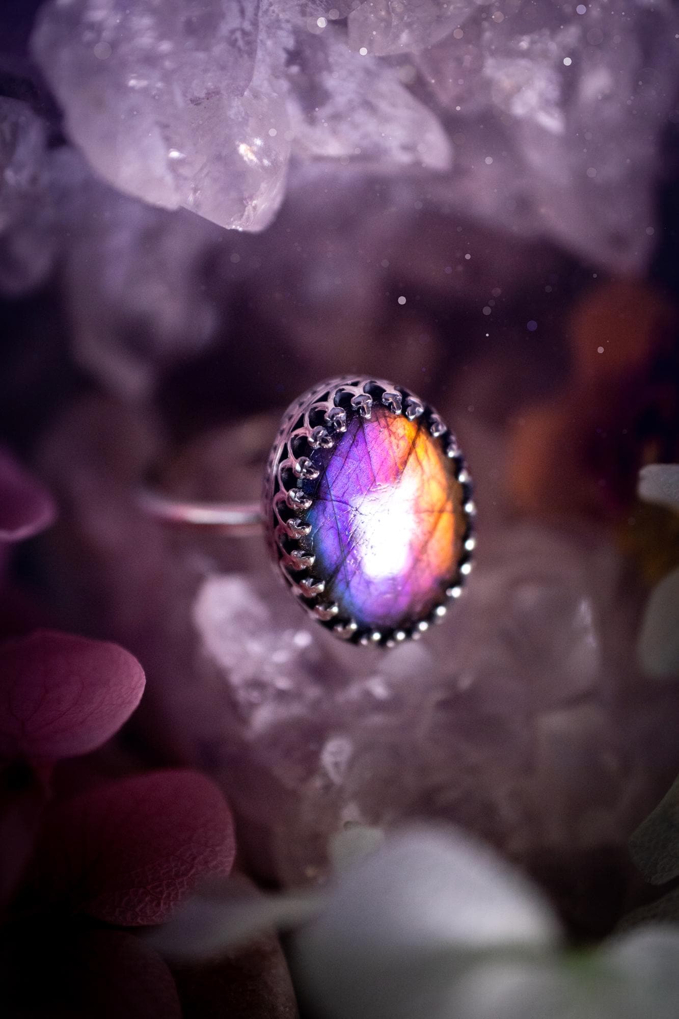 Handmade and very gothic, natural purple labradorite, sterling silver ring. This minimalist ring features a very pretty and flashy labradorite crystal that has a rich and vibrant purple colour. Around the crystal is a beautifully detail, gothic bezel that has been polished to a high lustre. The crystal is mounted on a 1.50mm ring shank. This ring would be ideal for anyone who loves jewellery and crystals, or who has a gothic and witchy style. A beautiful piece of jewellery to add to a collection