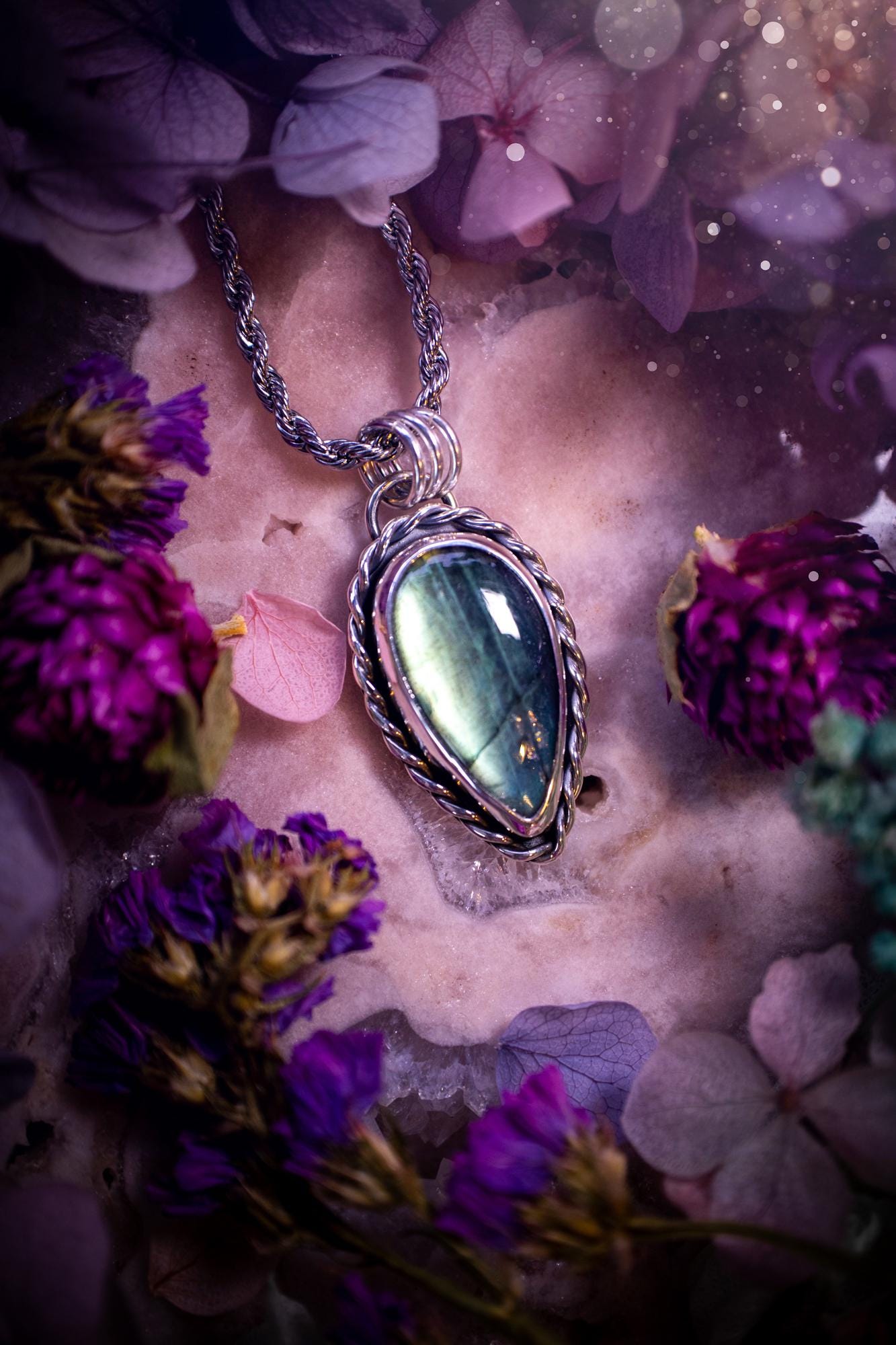 Beautifully handcrafted, nature green, flashy labradorite crystal pendant necklace. This beautiful pendant has been crafted out of sterling and fine silver and features gothic bezel wire around the labradorite crystal. The labradorite in this piece is full of beautiful green hues with a stunning pattern. A really beautiful crystal. This jewellery piece would be ideal for anyone who is a fan of jewellery and crystals, and would make the ideal gift. Full of witchy and gothic vibes!