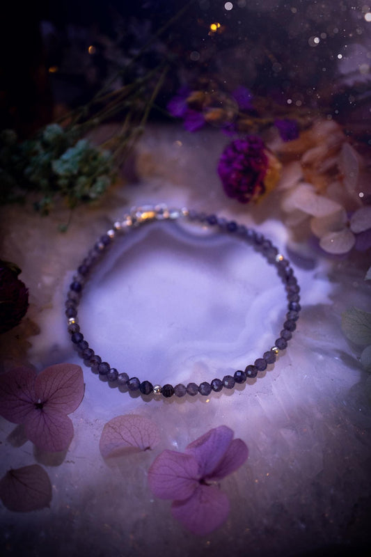 Beautifully handmade, and customisable, iolite crystal bead, stacking bracelet. This dainty crystal bracelet features high grade, genuine, rose cut, iolite crystal beads which give off a beautiful sparkle. They are a lovely purple and blue hue full of vibrancy. Strung on 49 strand beading wire with a choice of customisable findings to suit your style. Ideal for gifting, and suitable for any crystal and jewellery lover. Celestial, witchy and gothic.