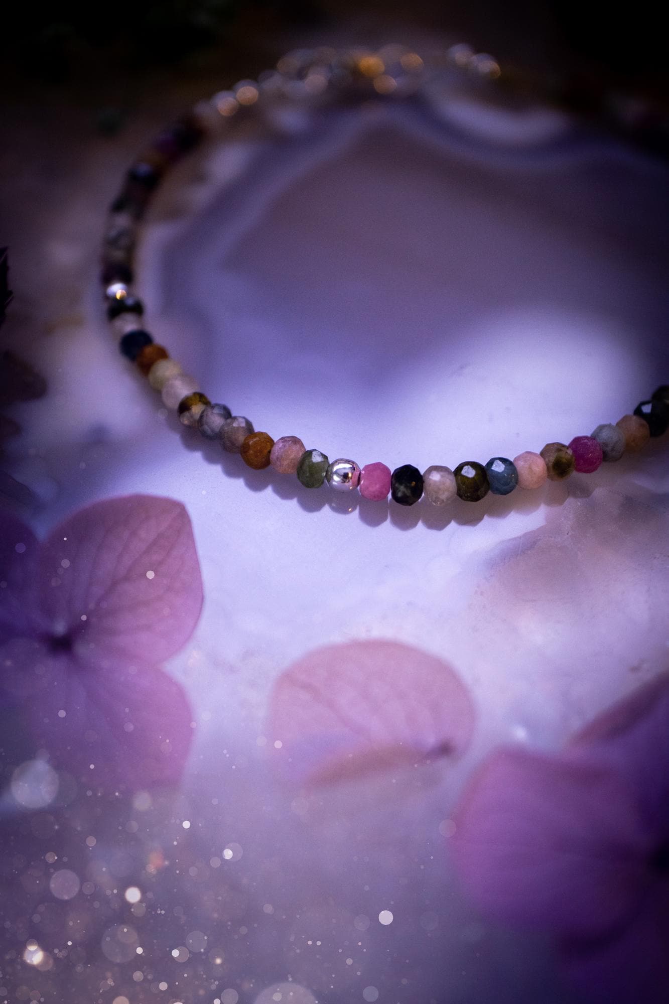 Beautifully handmade, and customisable, mixed tourmaline crystal bead, stacking bracelet. This dainty crystal bracelet features high grade, genuine, rose cut, tourmaline crystal beads which give off a beautiful sparkle. They are a lovely mix of hue, full of vibrancy. Strung on 49 strand beading wire with a choice of customisable findings to suit your style. Ideal for gifting, and suitable for any crystal and jewellery lover. Celestial, witchy and gothic.