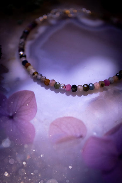 Beautifully handmade, and customisable, mixed tourmaline crystal bead, stacking bracelet. This dainty crystal bracelet features high grade, genuine, rose cut, tourmaline crystal beads which give off a beautiful sparkle. They are a lovely mix of hue, full of vibrancy. Strung on 49 strand beading wire with a choice of customisable findings to suit your style. Ideal for gifting, and suitable for any crystal and jewellery lover. Celestial, witchy and gothic.