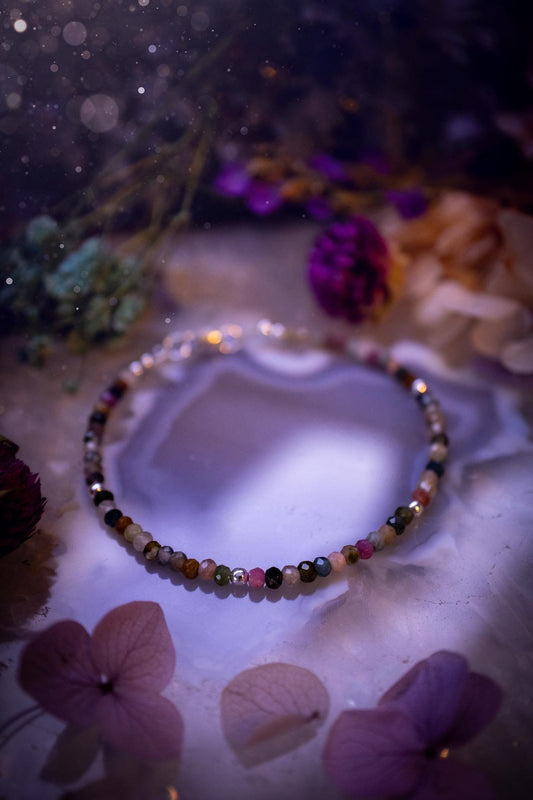 Beautifully handmade, and customisable, mixed tourmaline crystal bead, stacking bracelet. This dainty crystal bracelet features high grade, genuine, rose cut, tourmaline crystal beads which give off a beautiful sparkle. They are a lovely mix of hue, full of vibrancy. Strung on 49 strand beading wire with a choice of customisable findings to suit your style. Ideal for gifting, and suitable for any crystal and jewellery lover. Celestial, witchy and gothic.