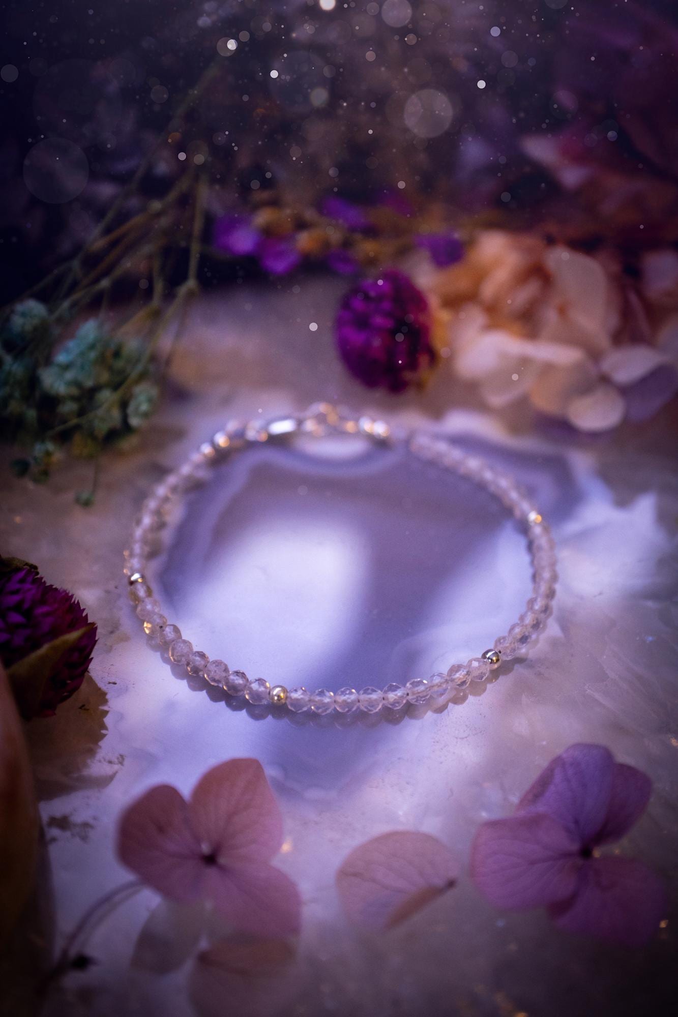 Beautifully handmade, and customisable, clear quartz crystal bead, stacking bracelet. This dainty crystal bracelet features high grade, genuine, rose cut, quartz crystal beads which give off a beautiful sparkle. Strung on 49 strand beading wire with a choice of customisable findings to suit your style. Ideal for gifting, and suitable for any crystal and jewellery lover. Celestial, witchy and gothic.