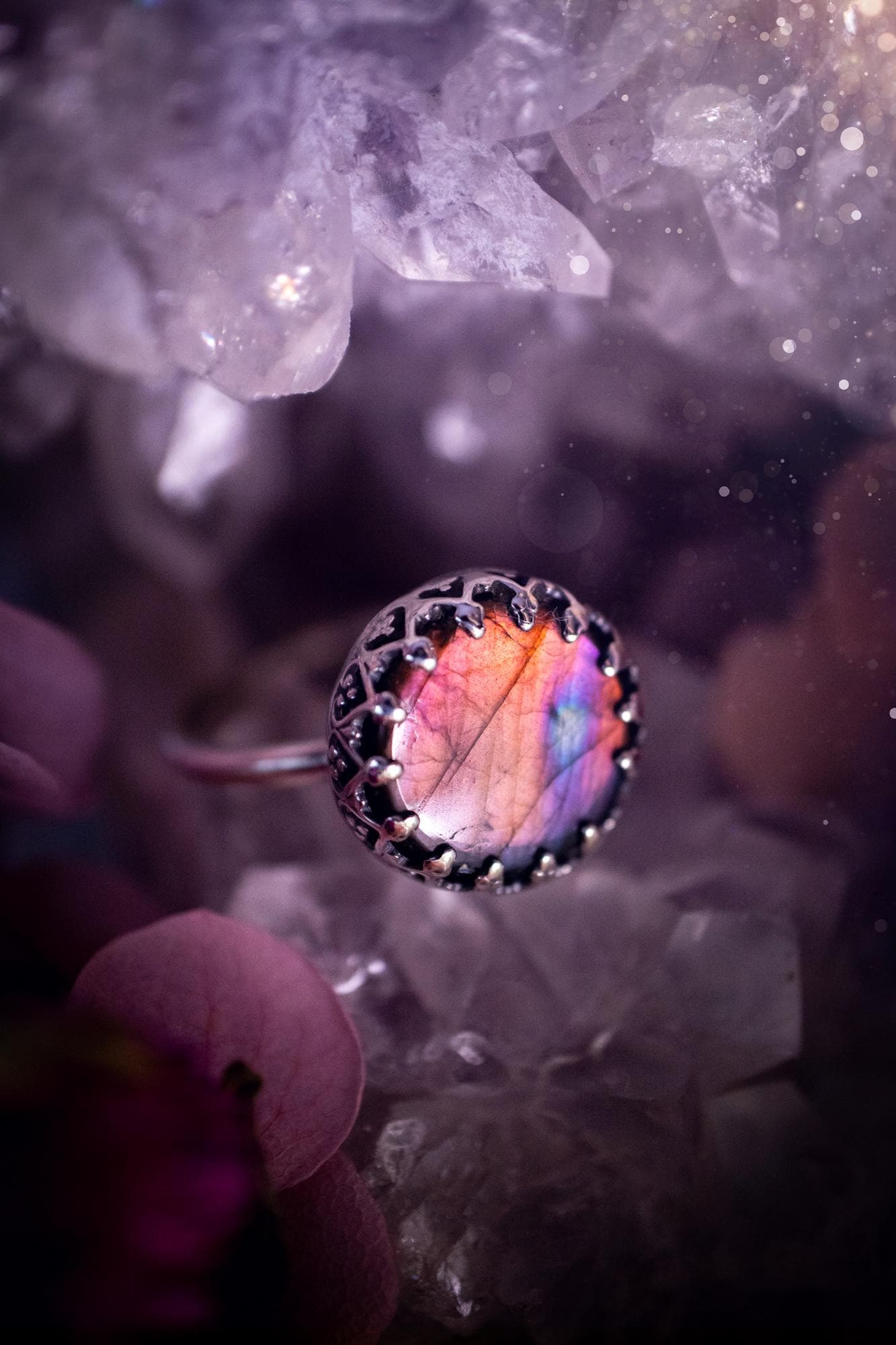 Handmade and very gothic, natural purple labradorite, sterling silver ring. This minimalist ring features a very pretty and flashy labradorite crystal that has a rich and vibrant purple colour. Around the crystal is a beautifully detail, gothic bezel that has been polished to a high lustre. The crystal is mounted on a 1.50mm ring shank. This ring would be ideal for anyone who loves jewellery and crystals, or who has a gothic and witchy style. A beautiful piece of jewellery to add to a collection