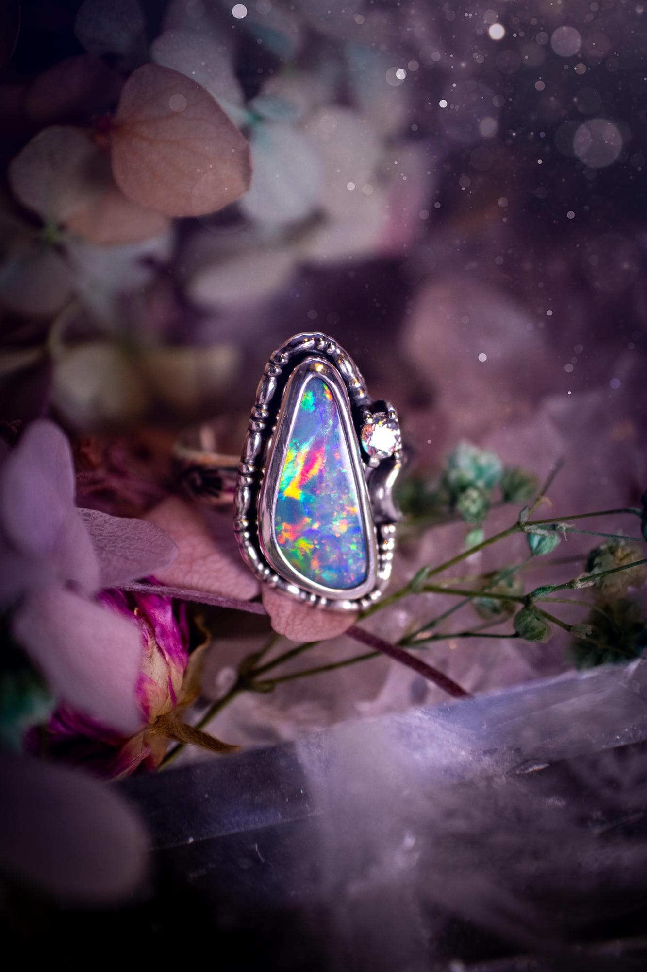 Handmade and totally bespoke, Australian Opal doublet, celestial style ring. This mini statement ring has been handmade using fine and sterling silver. Featuring a very beautiful and bold Australian Opal doublet that is full of colour play with lilac, reds, blues and greens that are super flashy! The ring is of a celestial style with a little moon and aurora coloured cubic zirconia to the side. This little ring would be suitable for anyone who loves crystals, opals and jewellery! Gothic vibes