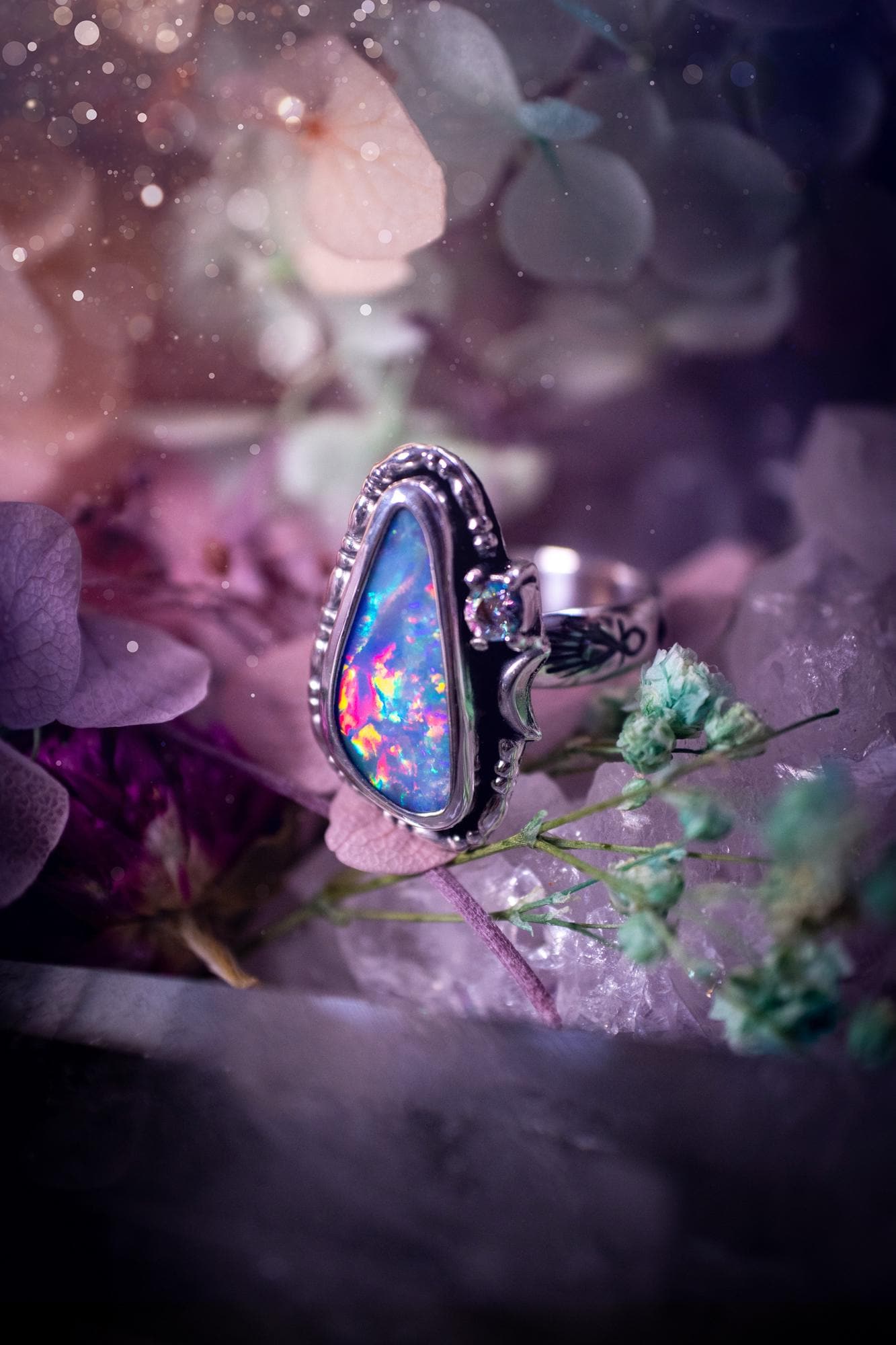 Handmade and totally bespoke, Australian Opal doublet, celestial style ring. This mini statement ring has been handmade using fine and sterling silver. Featuring a very beautiful and bold Australian Opal doublet that is full of colour play with lilac, reds, blues and greens that are super flashy! The ring is of a celestial style with a little moon and aurora coloured cubic zirconia to the side. This little ring would be suitable for anyone who loves crystals, opals and jewellery! Gothic vibes