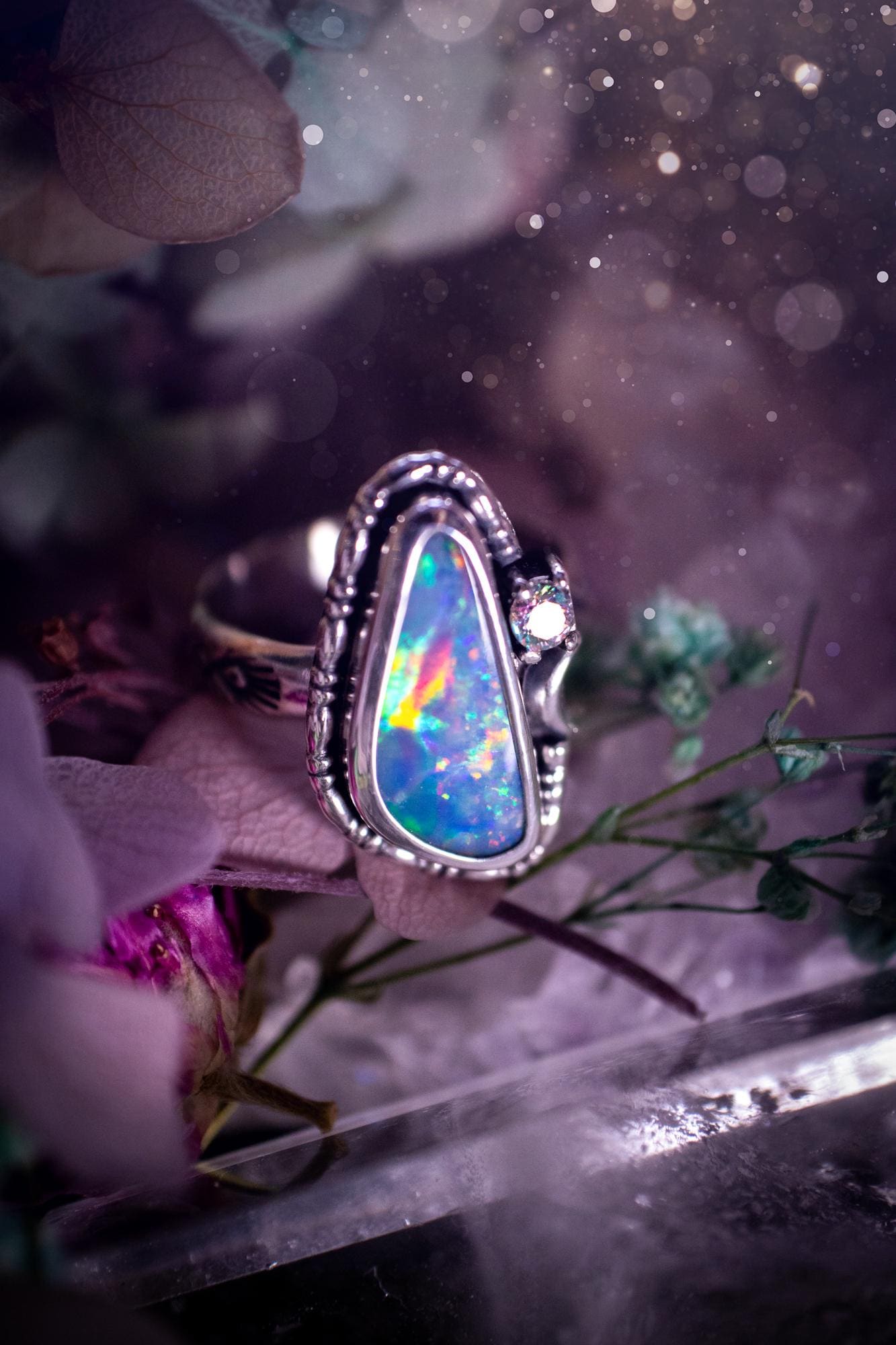 Handmade and totally bespoke, Australian Opal doublet, celestial style ring. This mini statement ring has been handmade using fine and sterling silver. Featuring a very beautiful and bold Australian Opal doublet that is full of colour play with lilac, reds, blues and greens that are super flashy! The ring is of a celestial style with a little moon and aurora coloured cubic zirconia to the side. This little ring would be suitable for anyone who loves crystals, opals and jewellery! Gothic vibes