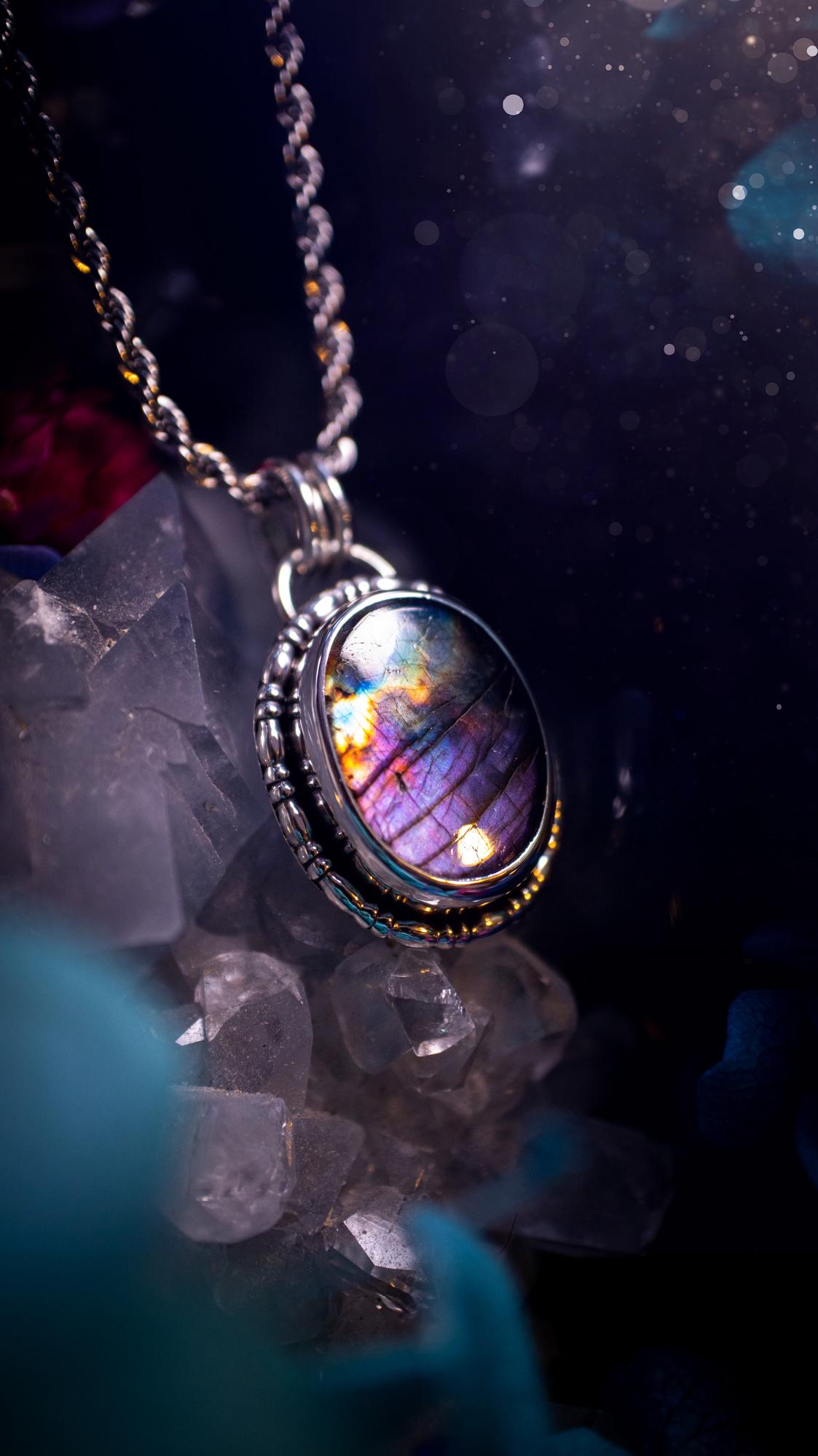 Beautifully handcrafted, rainbow labradorite crystal pendant necklace. This beautiful pendant has been crafted out of sterling and fine silver and features gothic bezel wire around the labradorite crystal. The labradorite in this piece is full of beautiful colours, purple, pinks and colours of the rainbow! This jewellery piece would be ideal for anyone who is a fan of jewellery and crystals, and would make the ideal gift. Full of witchy and gothic vibes!