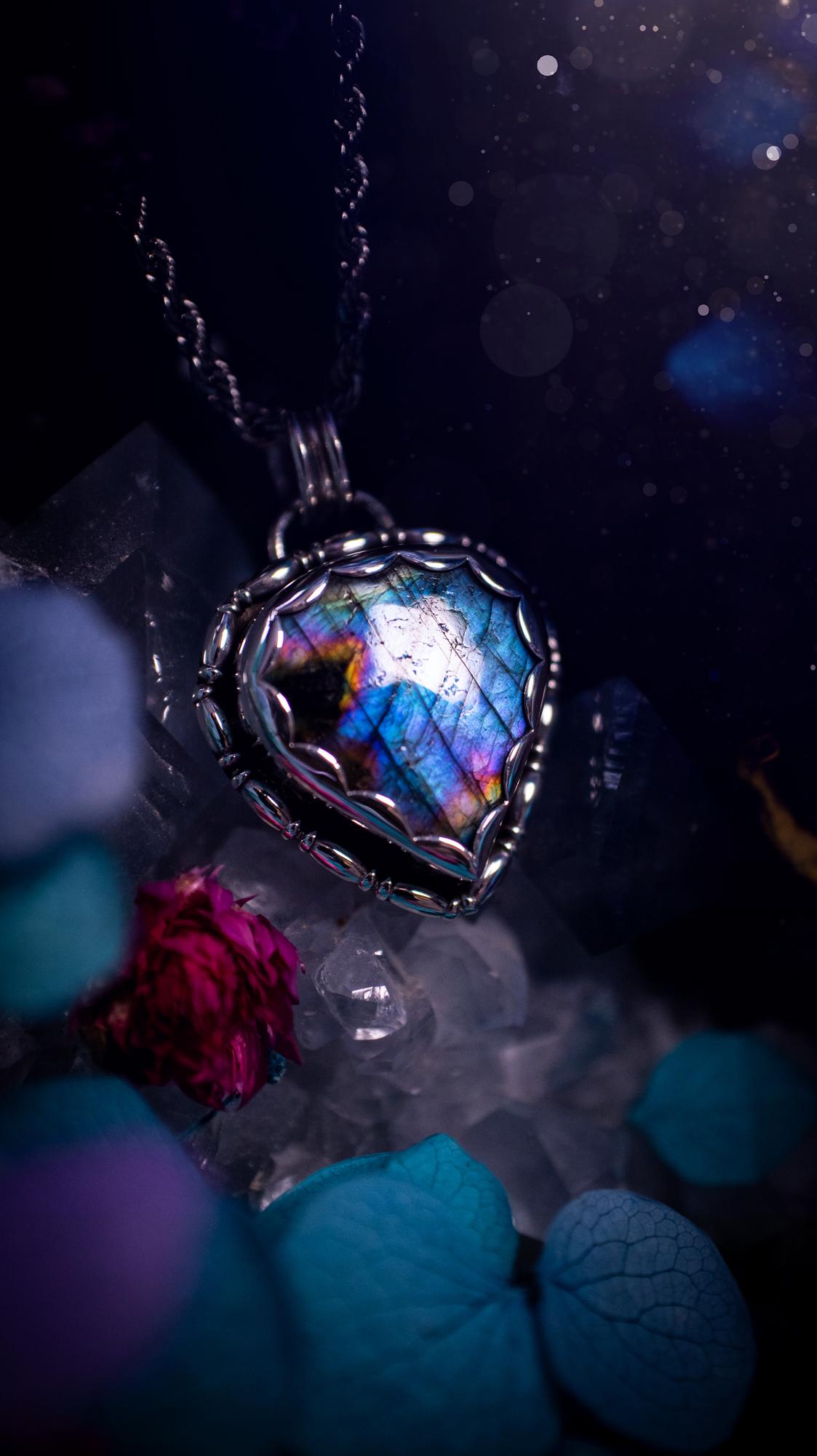 Beautifully handcrafted, rainbow labradorite crystal pendant necklace. This beautiful pendant has been crafted out of sterling and fine silver and features gothic bezel wire around the labradorite crystal in a scallop bezel. The labradorite in this piece is full of beautiful colours, purple, pinks and colours of the rainbow! This jewellery piece would be ideal for anyone who is a fan of jewellery and crystals, and would make the ideal gift. Full of witchy and gothic vibes!