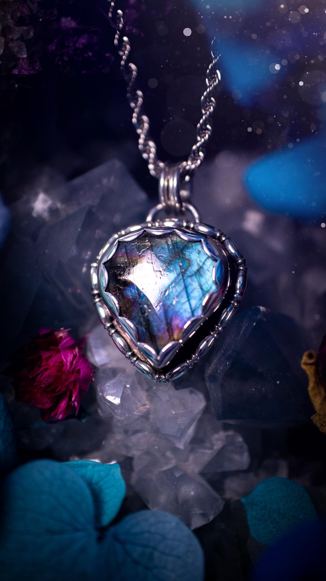 Beautifully handcrafted, rainbow labradorite crystal pendant necklace. This beautiful pendant has been crafted out of sterling and fine silver and features gothic bezel wire around the labradorite crystal in a scallop bezel. The labradorite in this piece is full of beautiful colours, purple, pinks and colours of the rainbow! This jewellery piece would be ideal for anyone who is a fan of jewellery and crystals, and would make the ideal gift. Full of witchy and gothic vibes!