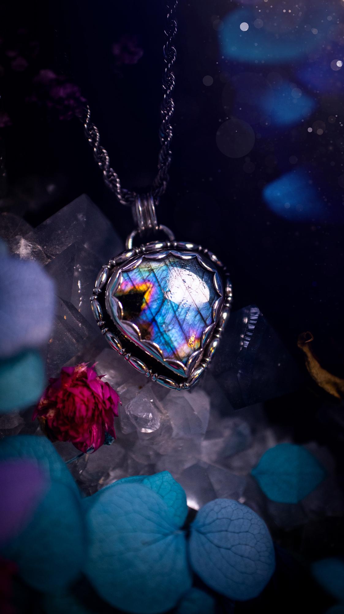 Beautifully handcrafted, rainbow labradorite crystal pendant necklace. This beautiful pendant has been crafted out of sterling and fine silver and features gothic bezel wire around the labradorite crystal in a scallop bezel. The labradorite in this piece is full of beautiful colours, purple, pinks and colours of the rainbow! This jewellery piece would be ideal for anyone who is a fan of jewellery and crystals, and would make the ideal gift. Full of witchy and gothic vibes!