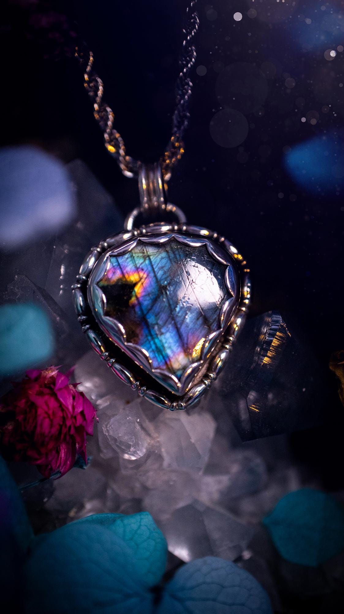 Beautifully handcrafted, rainbow labradorite crystal pendant necklace. This beautiful pendant has been crafted out of sterling and fine silver and features gothic bezel wire around the labradorite crystal in a scallop bezel. The labradorite in this piece is full of beautiful colours, purple, pinks and colours of the rainbow! This jewellery piece would be ideal for anyone who is a fan of jewellery and crystals, and would make the ideal gift. Full of witchy and gothic vibes!