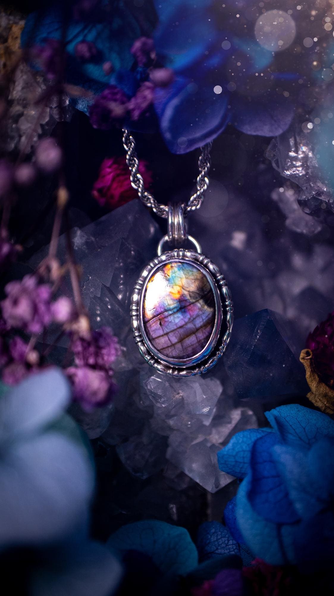 Beautifully handcrafted, rainbow labradorite crystal pendant necklace. This beautiful pendant has been crafted out of sterling and fine silver and features gothic bezel wire around the labradorite crystal. The labradorite in this piece is full of beautiful colours, purple, pinks and colours of the rainbow! This jewellery piece would be ideal for anyone who is a fan of jewellery and crystals, and would make the ideal gift. Full of witchy and gothic vibes!