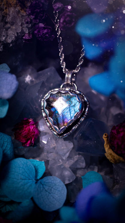 Beautifully handcrafted, rainbow labradorite crystal pendant necklace. This beautiful pendant has been crafted out of sterling and fine silver and features gothic bezel wire around the labradorite crystal in a scallop bezel. The labradorite in this piece is full of beautiful colours, purple, pinks and colours of the rainbow! This jewellery piece would be ideal for anyone who is a fan of jewellery and crystals, and would make the ideal gift. Full of witchy and gothic vibes!